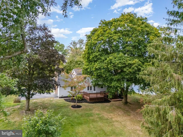 a view of a house with yard and sitting area