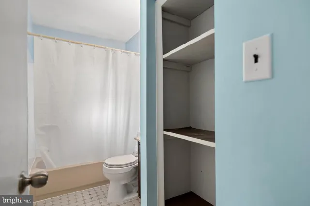 a bathroom with a toilet and a shower