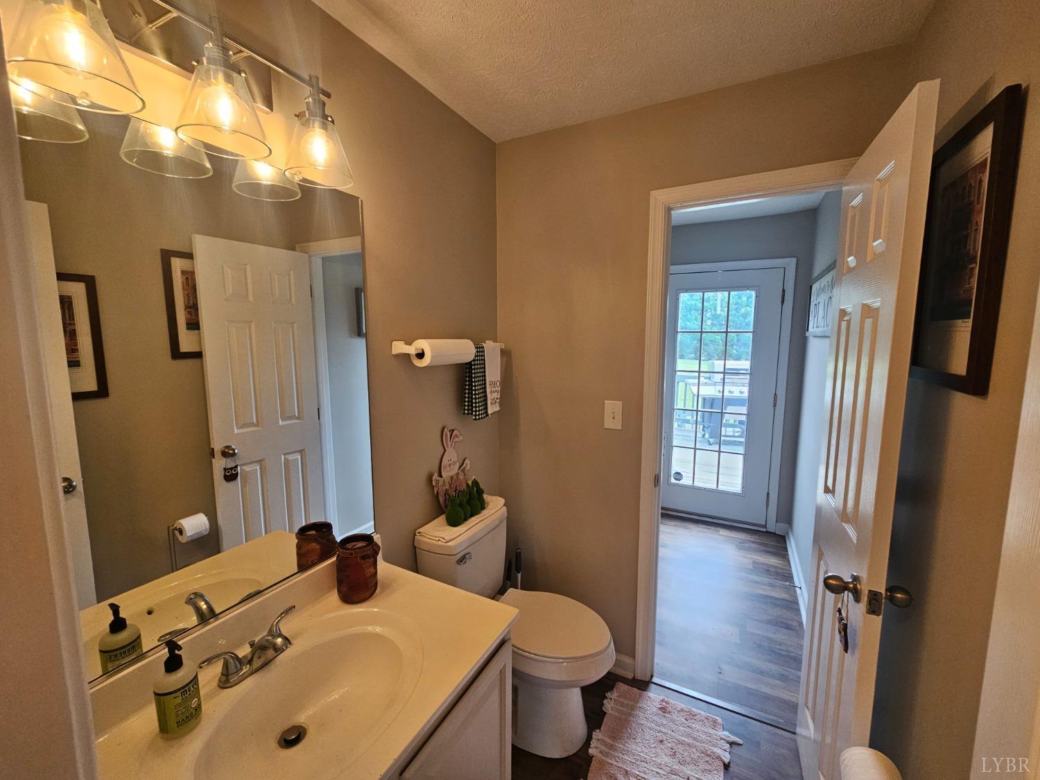 1390 Jacobs Road Hurt, VA 24563 - Photo 13 of 30 a bathroom with a sink and mirror with toilet