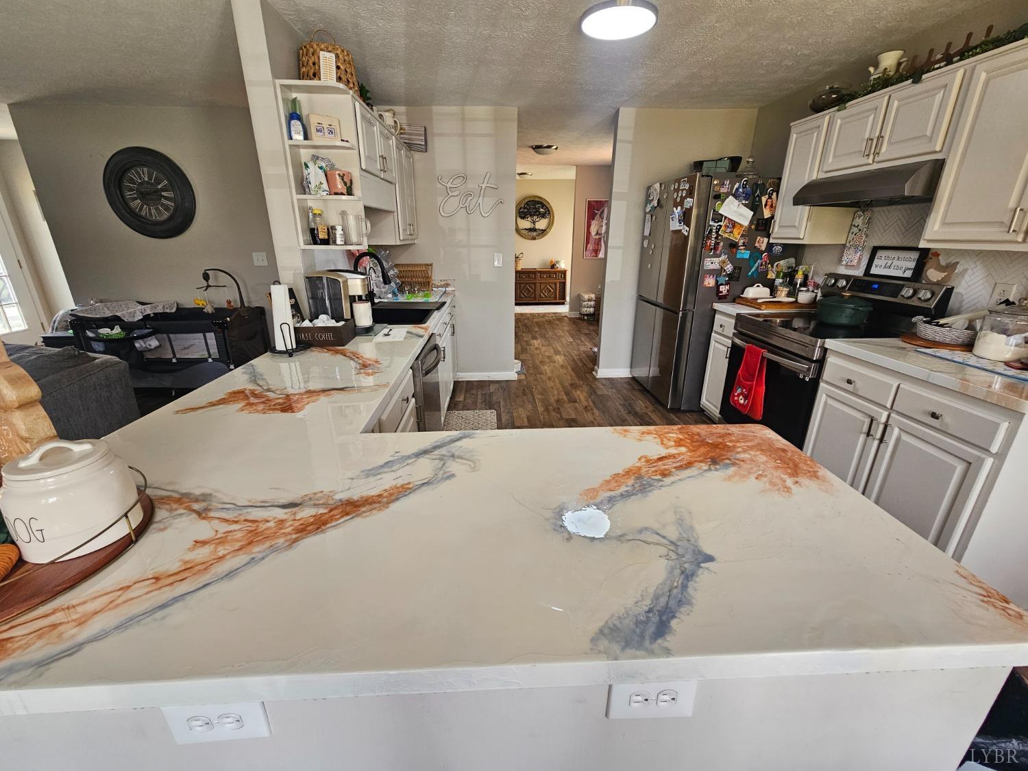 1390 Jacobs Road Hurt, VA 24563 - Photo 6 of 30 a room with granite countertop a sink a stove and a refrigerator