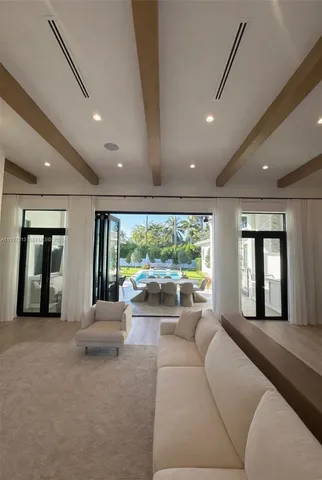 a living room with furniture and large windows