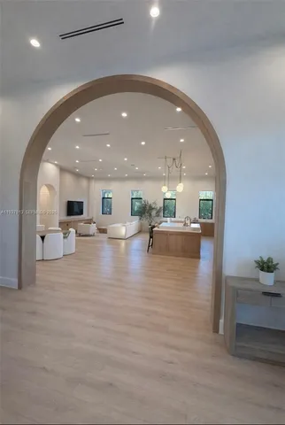 a view of kitchen and hall with living room