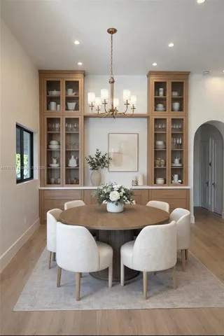 a view of a dining room with furniture and chandelier