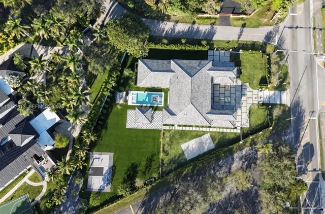 an aerial view of a house with a yard basket ball court