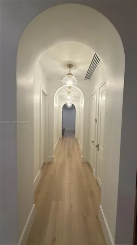 a view of a hallway with a chandelier