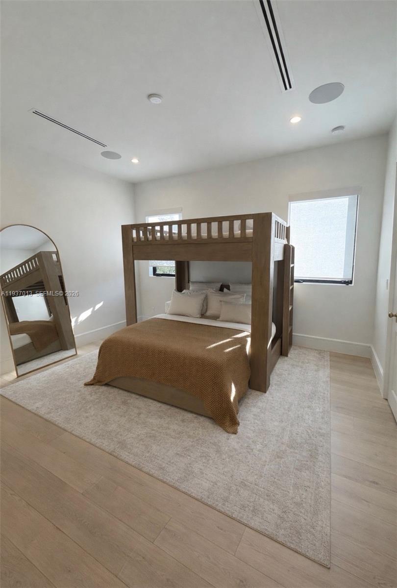 14200 Old Cutler Road Palmetto Bay, FL 33158 - Photo 22 of 43 a bedroom with a bed and a mirror