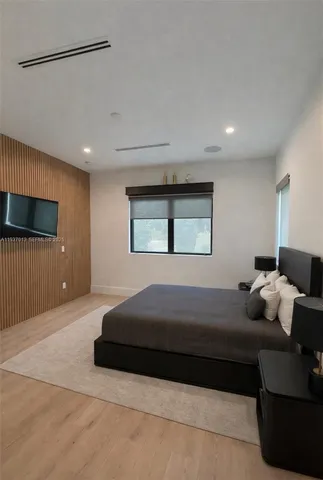 a bedroom with a bed and a television