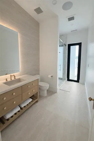 a bathroom with a double vanity sink toilet and a tub