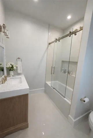 a bathroom with a sink a mirror and a shower