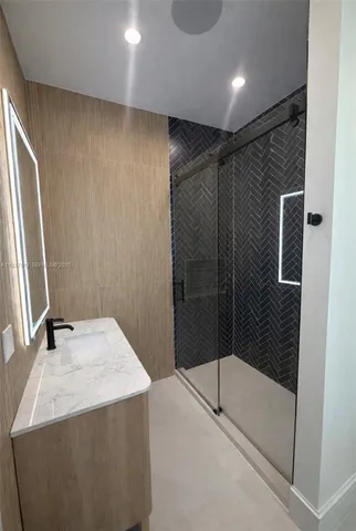 a bathroom with a shower and a sink