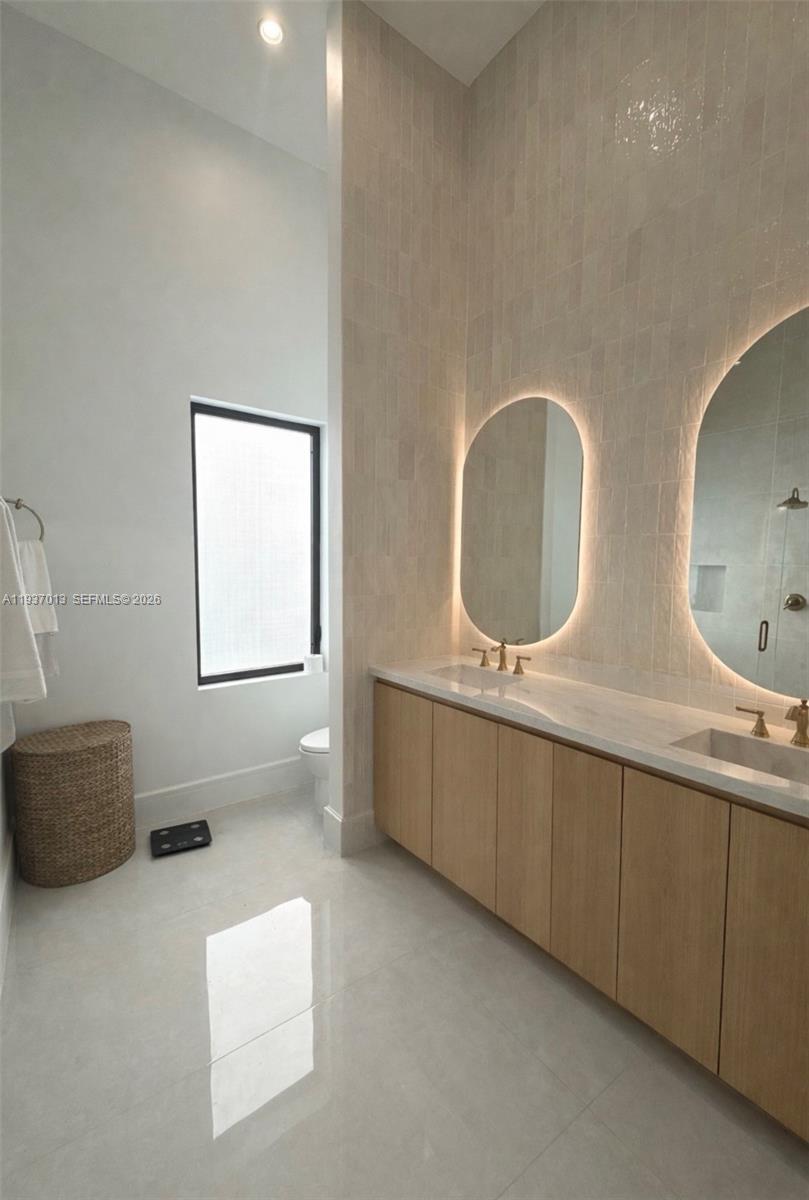 14200 Old Cutler Road Palmetto Bay, FL 33158 - Photo 32 of 43 a bathroom with double vanity sink and mirror