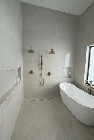 a spacious bathroom with a double vanity sink a toilet and shower