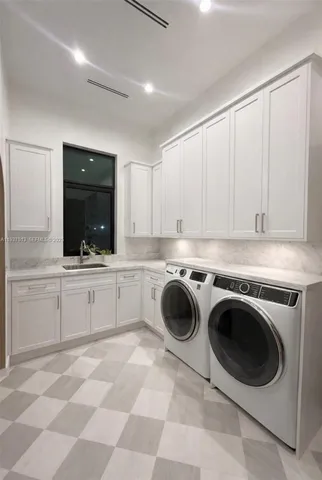 a kitchen with a stove top oven sink and cabinets