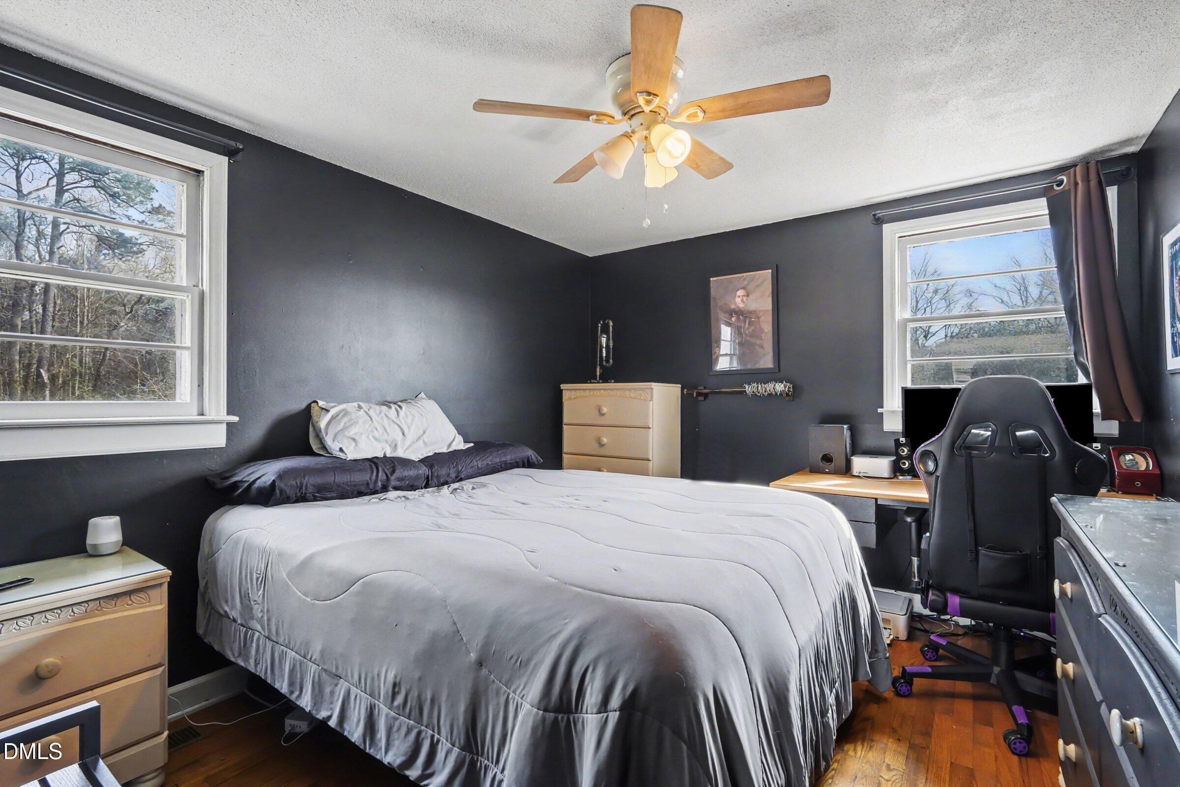 5776 Pearces Road Louisburg, NC 27549 - Photo 11 of 32 a bedroom with a bed and a chandelier