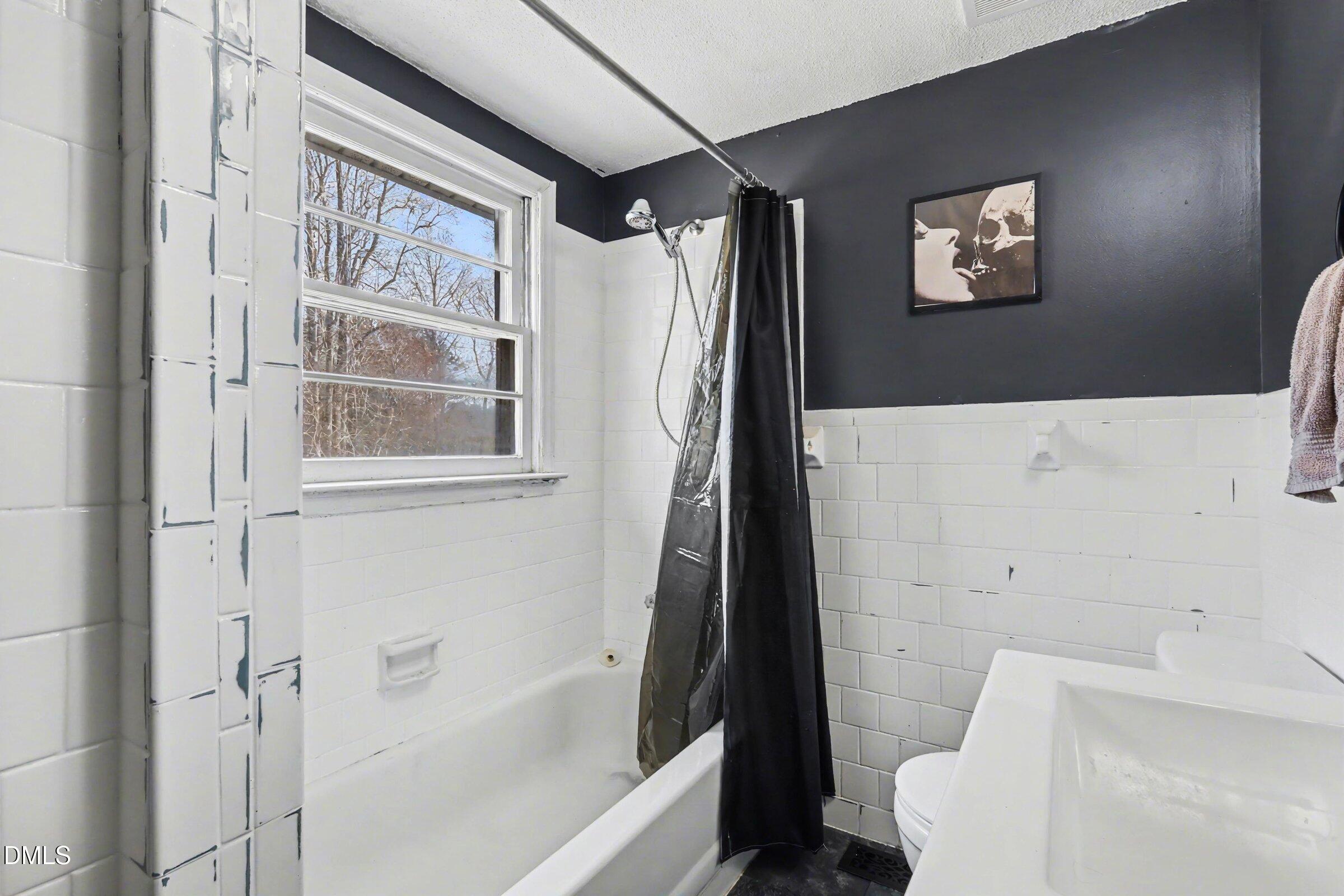 5776 Pearces Road Louisburg, NC 27549 - Photo 12 of 32 a bathroom with a bathtub and a shower