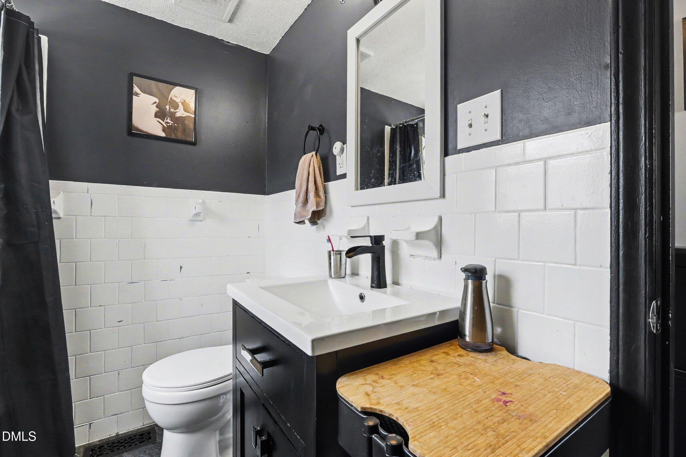 5776 Pearces Road Louisburg, NC 27549 - Photo 13 of 32 a bathroom with a sink toilet and a mirror