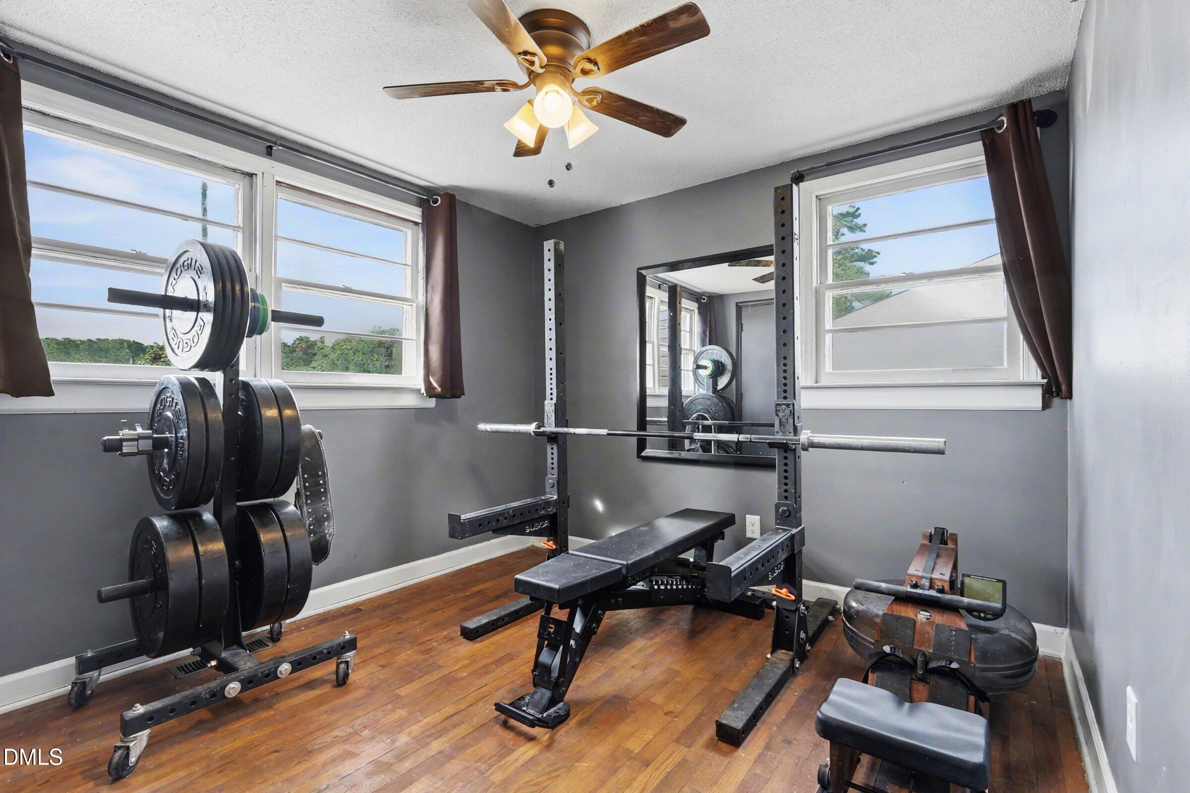 5776 Pearces Road Louisburg, NC 27549 - Photo 14 of 32 a room with gym equipment and windows