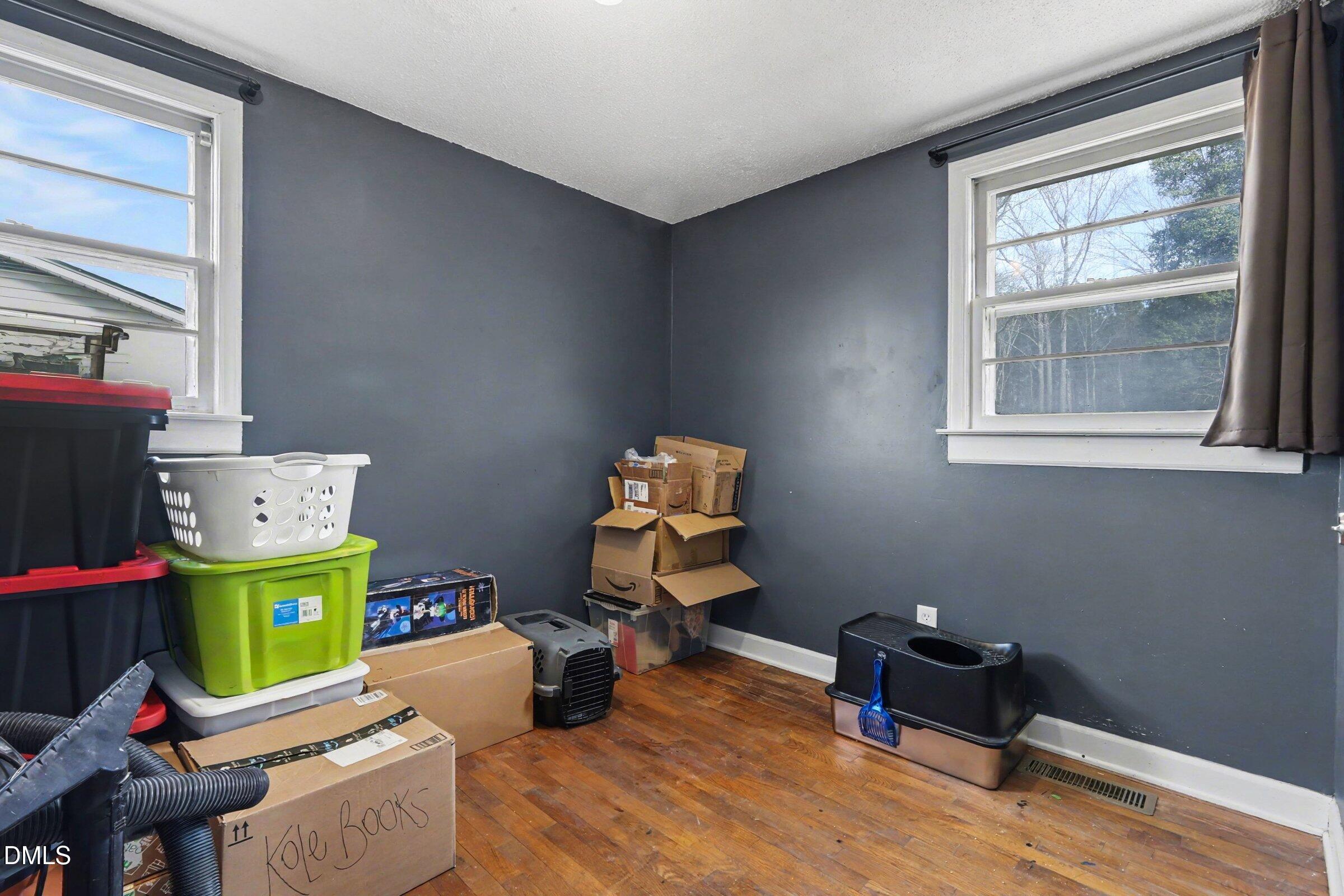 5776 Pearces Road Louisburg, NC 27549 - Photo 17 of 32 a room with furniture and a wooden floor
