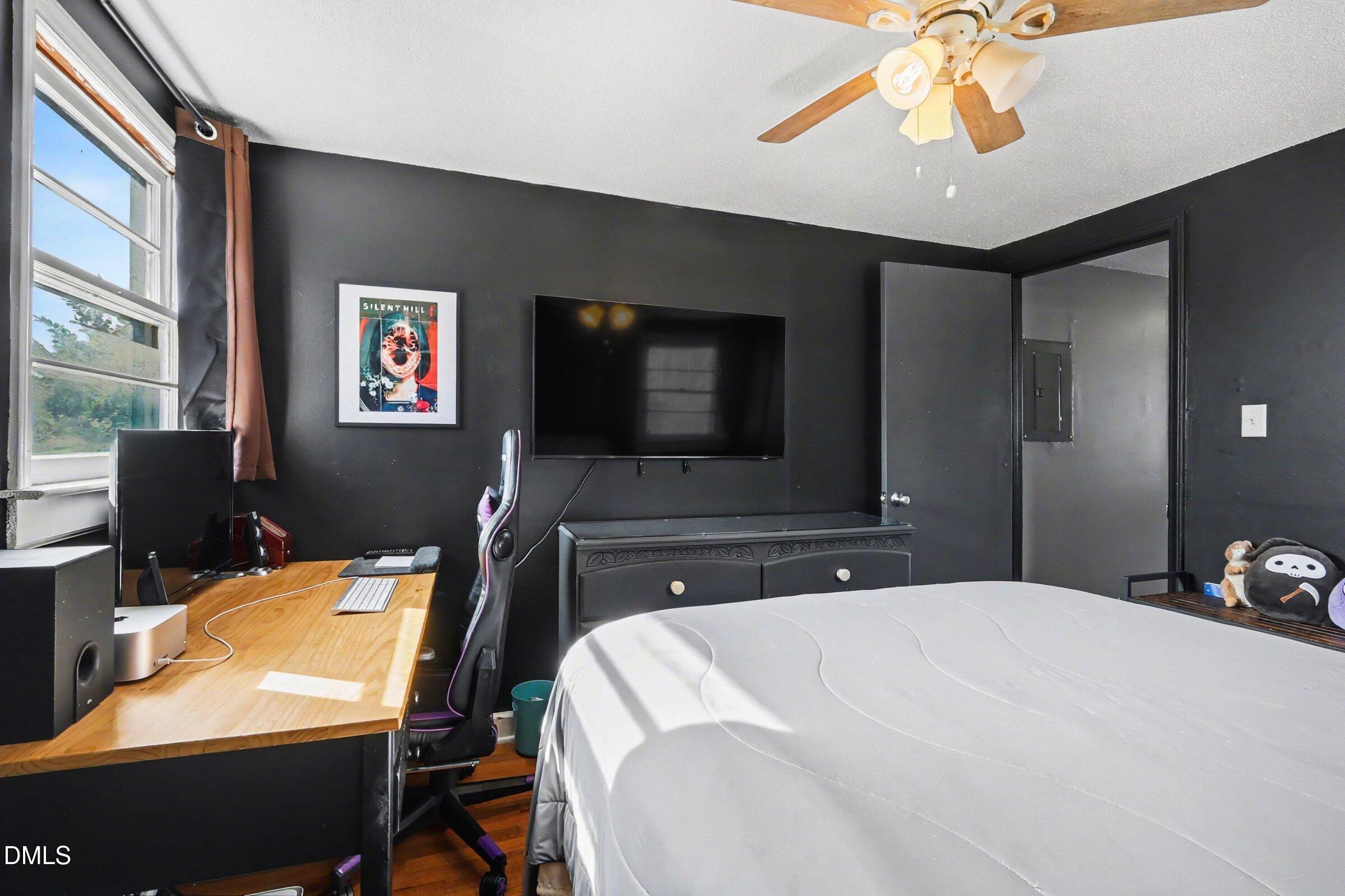 5776 Pearces Road Louisburg, NC 27549 - Photo 20 of 32 a bedroom with a bed and a flat screen tv