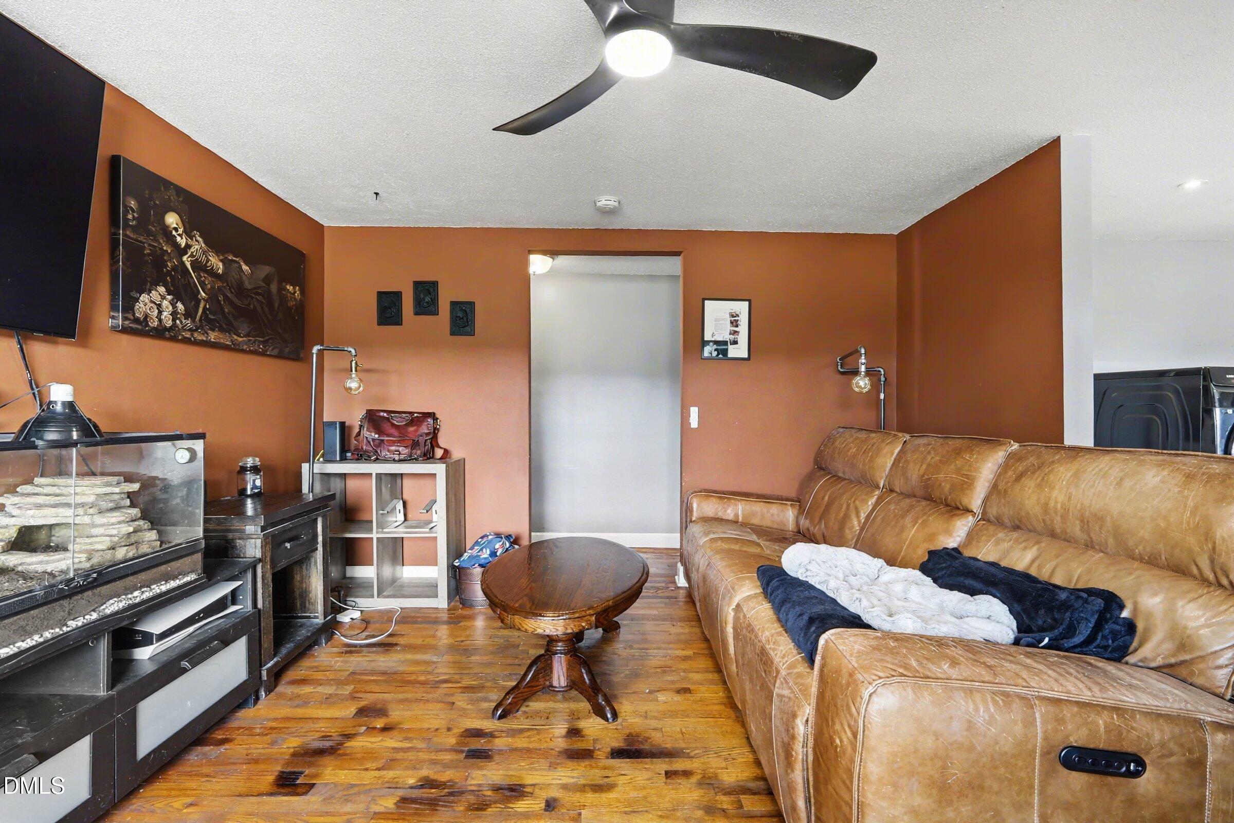 5776 Pearces Road Louisburg, NC 27549 - Photo 21 of 32 a living room with furniture and a flat screen tv