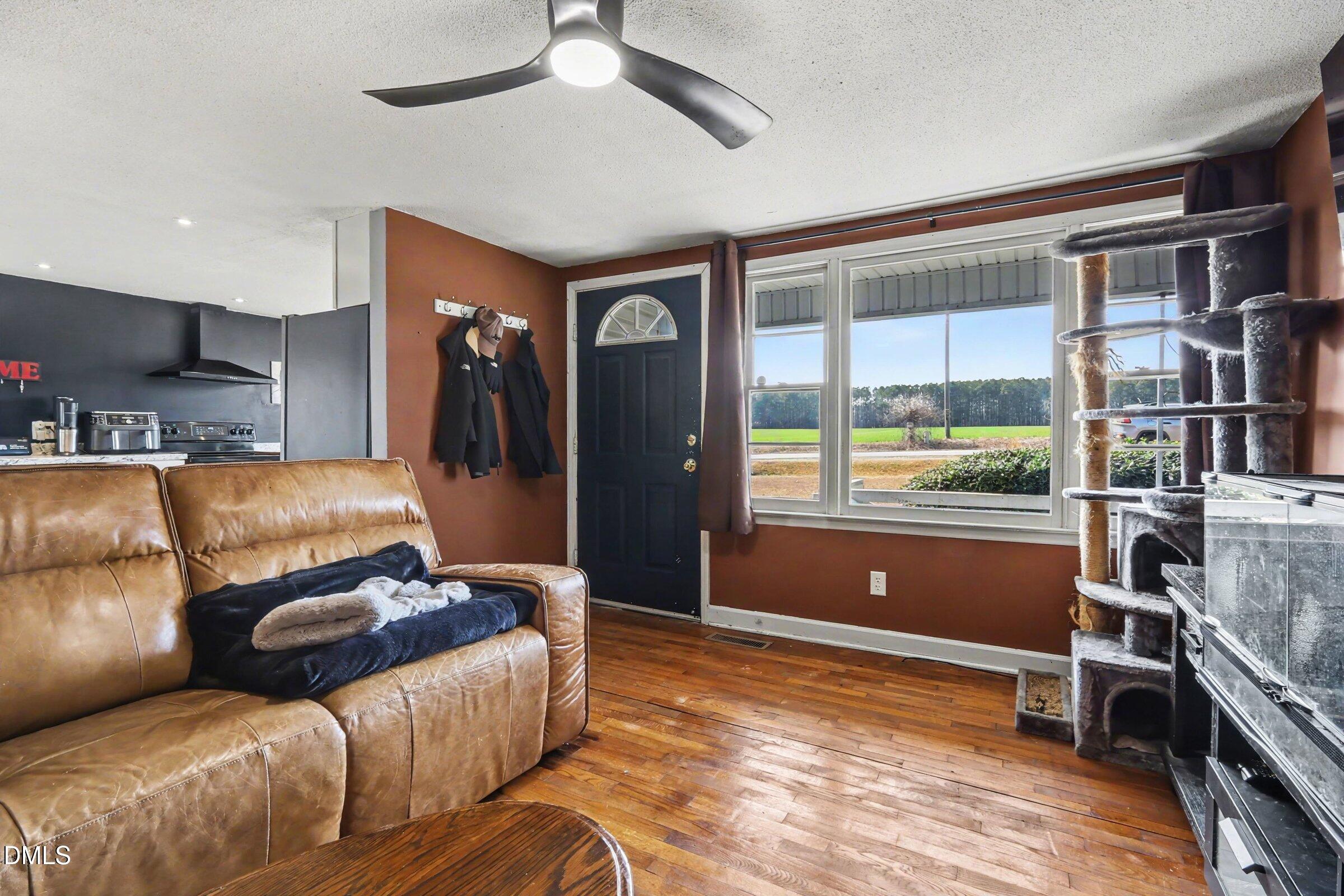 5776 Pearces Road Louisburg, NC 27549 - Photo 23 of 32 a living room with furniture and a window