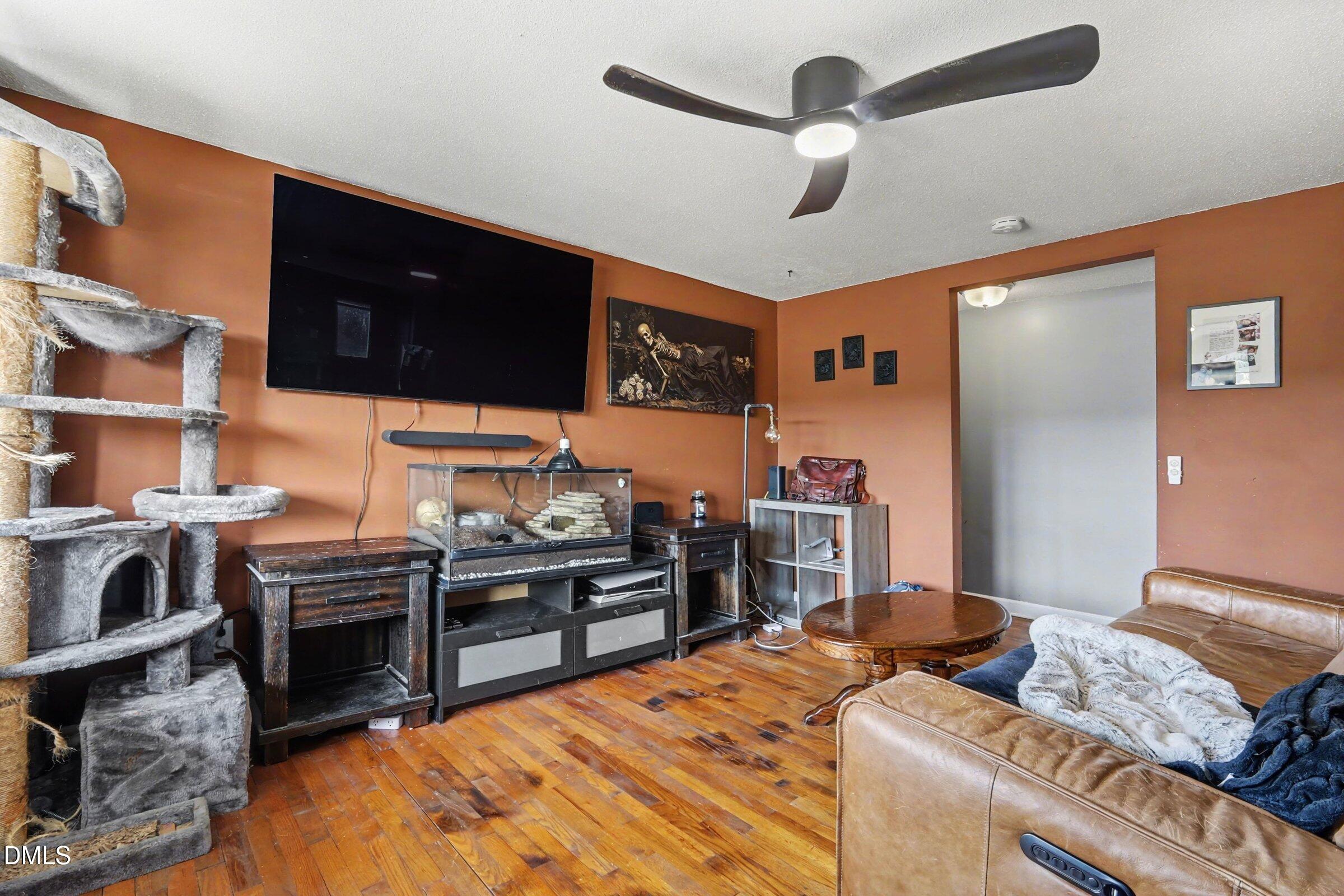 5776 Pearces Road Louisburg, NC 27549 - Photo 24 of 32 a bedroom with furniture and a flat screen tv