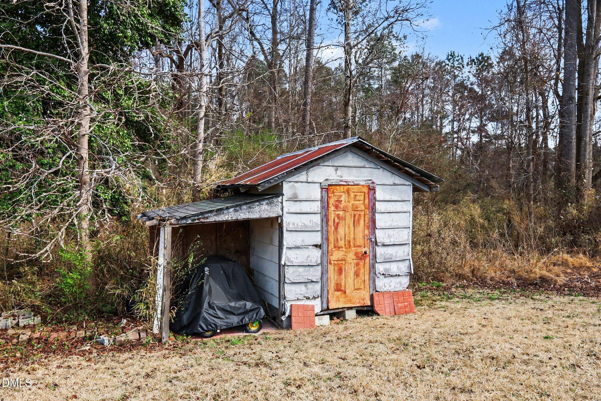 5776 Pearces Road Louisburg, NC 27549 - Photo 27 of 32 a view of a wooden house with large trees
