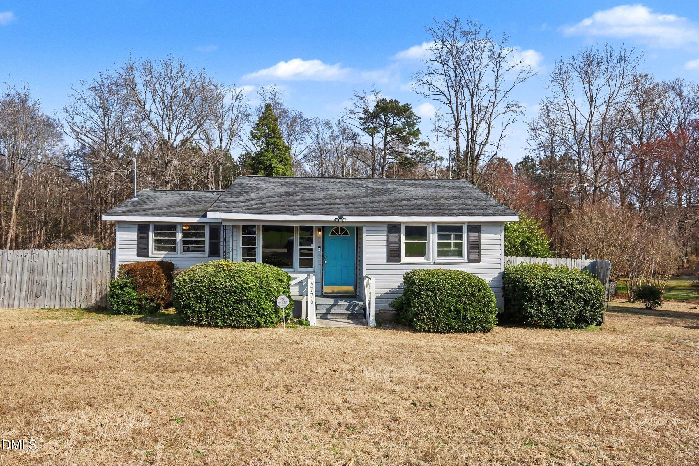 5776 Pearces Road Louisburg, NC 27549 - Photo 2 of 32 a front view of a house with garden
