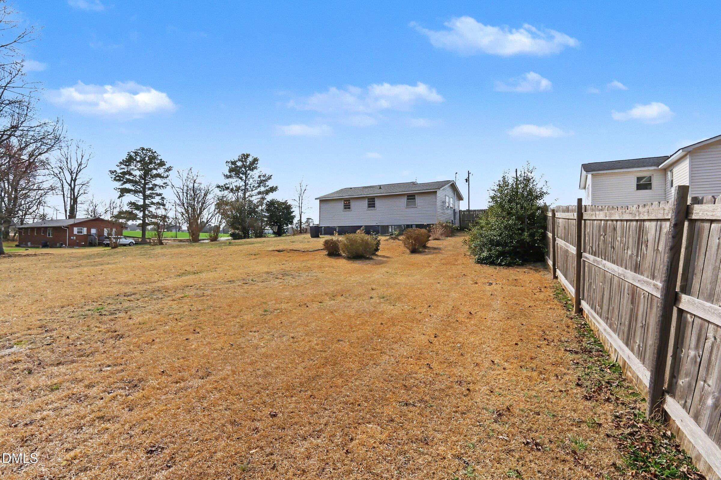 5776 Pearces Road Louisburg, NC 27549 - Photo 31 of 32 a view of a house with backyard and garden