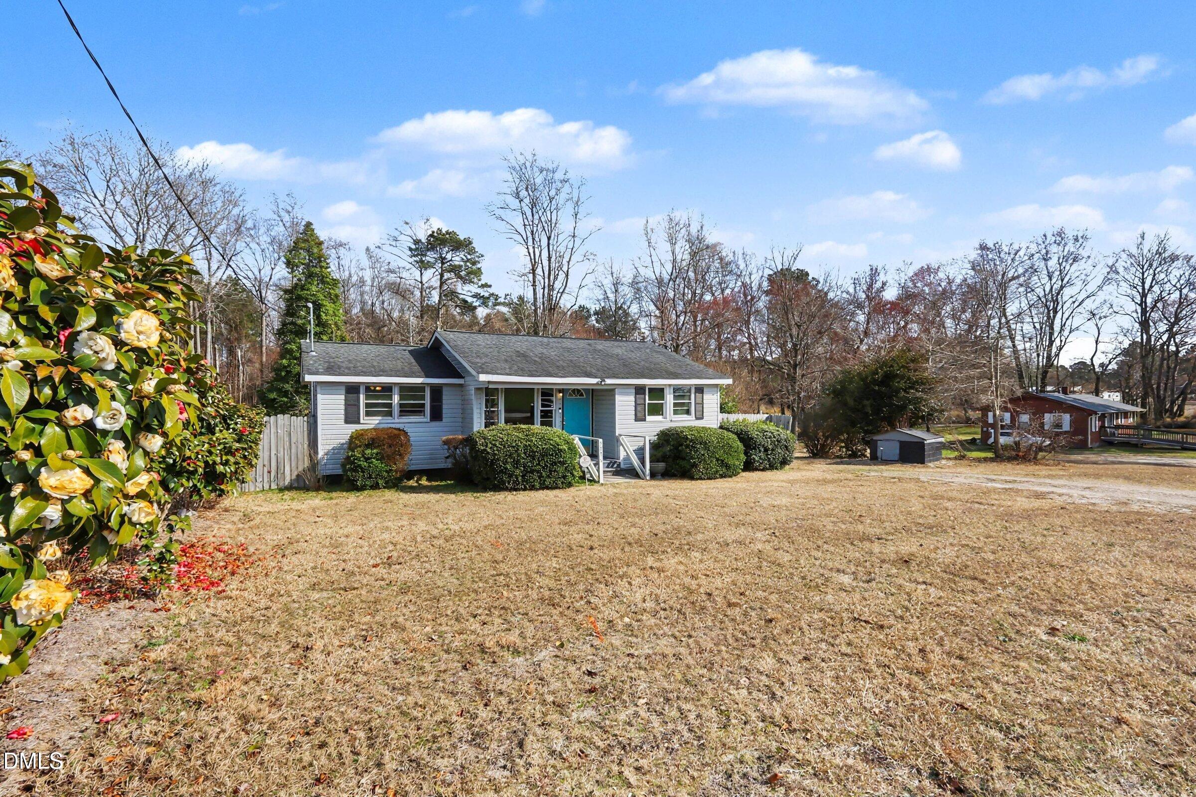 5776 Pearces Road Louisburg, NC 27549 - Photo 3 of 32 a front view of a house with a yard and trees