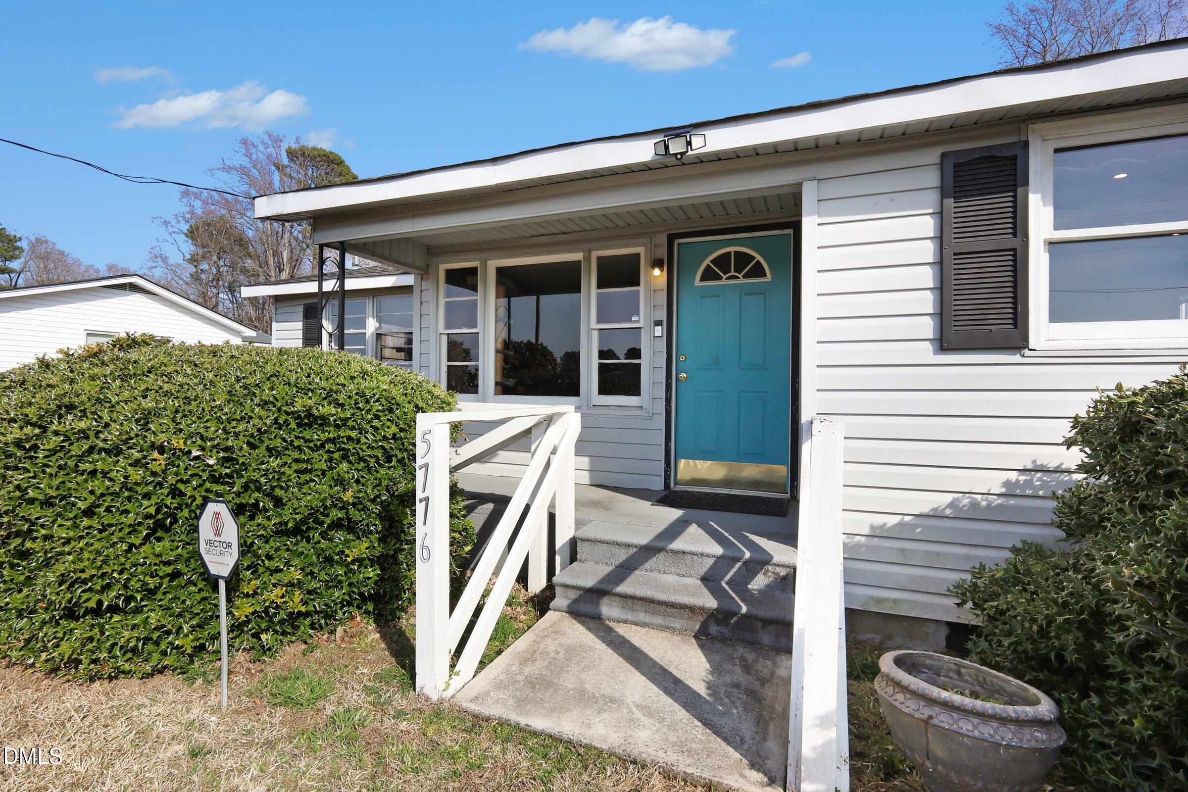 5776 Pearces Road Louisburg, NC 27549 - Photo 5 of 32 a view of a patio with table and chairs and potted plants