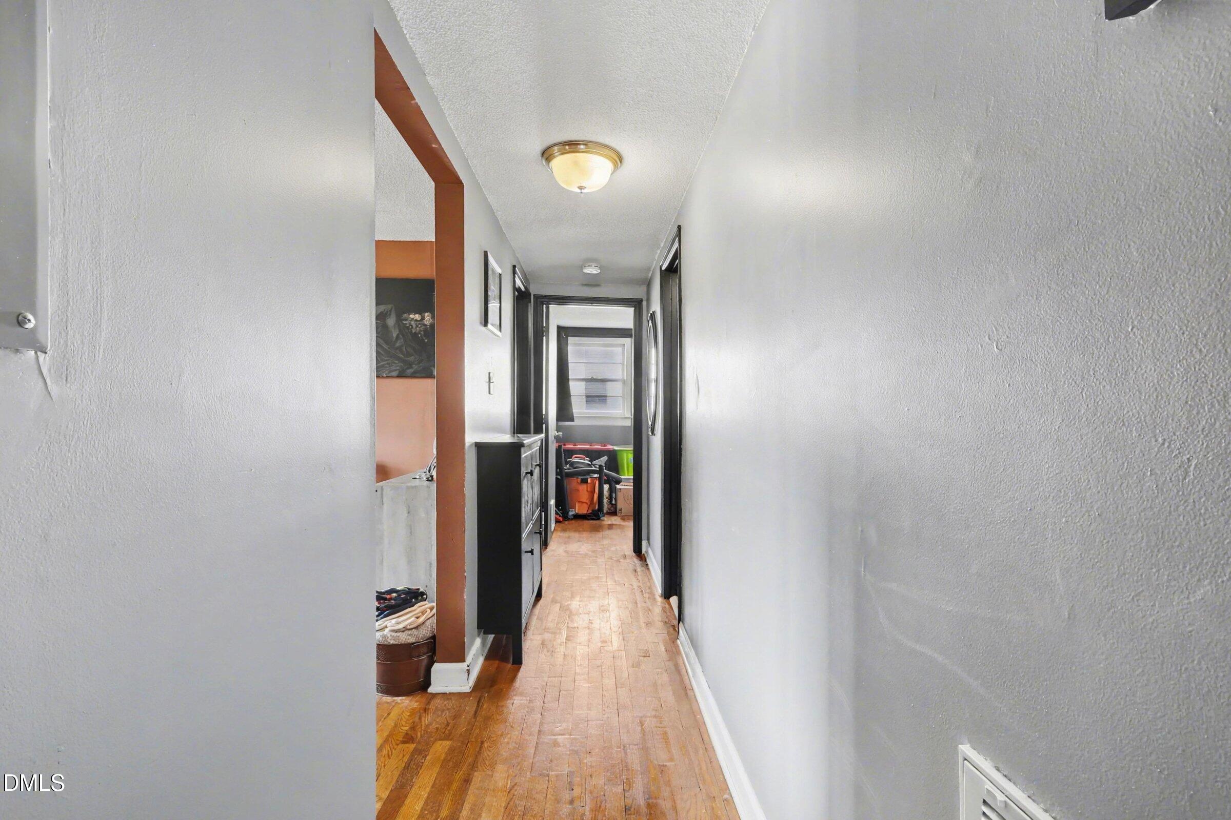 5776 Pearces Road Louisburg, NC 27549 - Photo 7 of 32 a view of a hallway with wooden floor