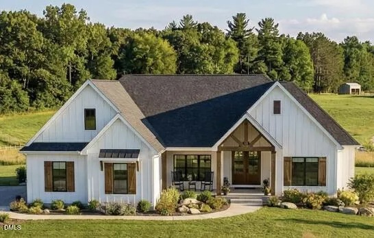 a view of house with yard and green space