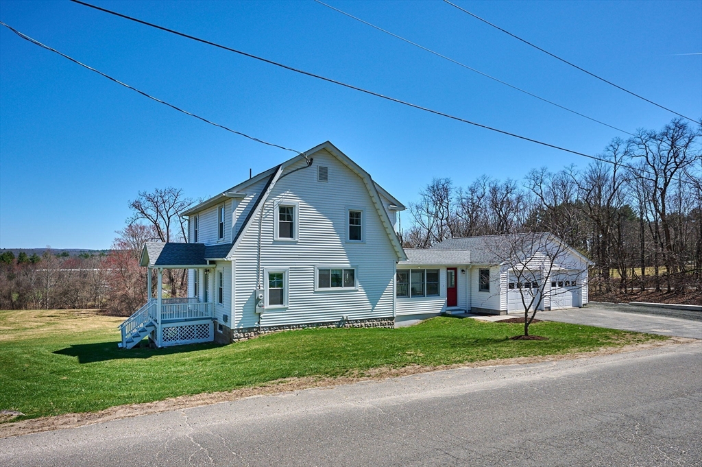 69 High Street Southampton, MA 01073 - Photo 1 of 40 a front view of a house with a yard and garage