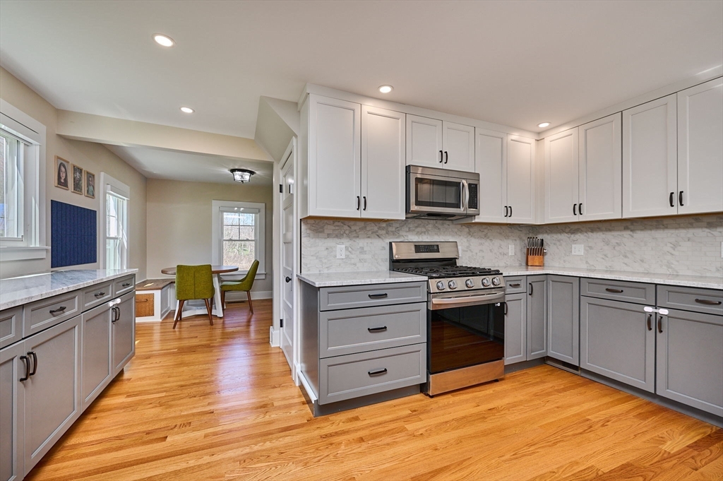 69 High Street Southampton, MA 01073 - Photo 12 of 40 a kitchen with stainless steel appliances granite countertop a stove top oven a sink dishwasher and a refrigerator with wooden floor