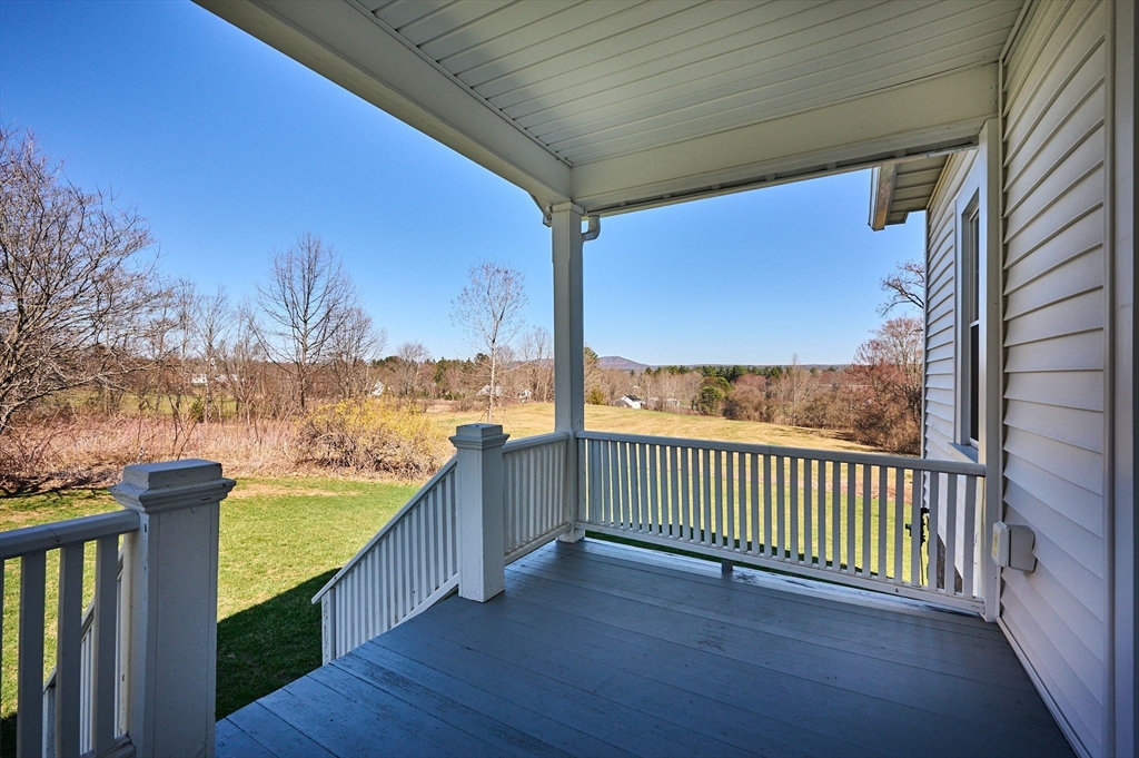 69 High Street Southampton, MA 01073 - Photo 4 of 40 a view of a porch with wooden floor and roof with floor to ceiling window