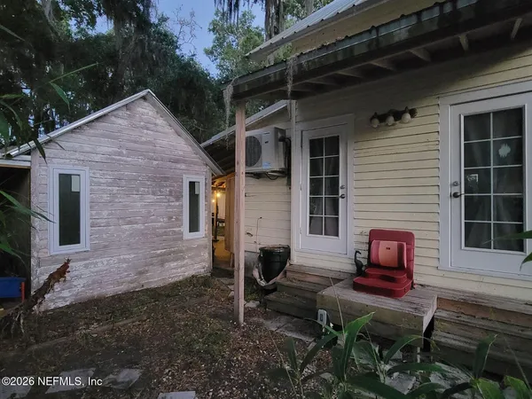a front view of a house with a yard and outdoor seating