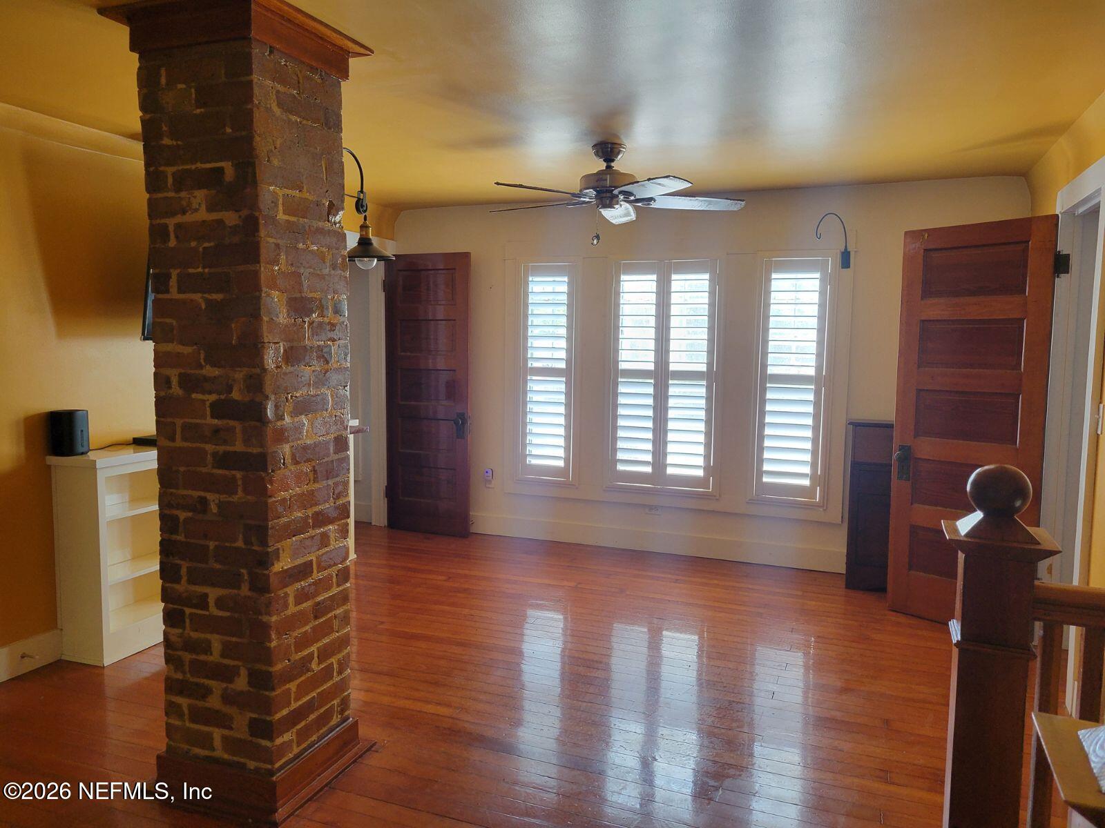 216 Summit Street Crescent City, FL 32112 - Photo 8 of 46 a view of an empty room with a window and wooden floor