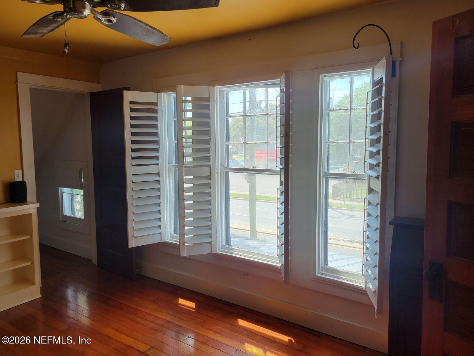 216 Summit Street Crescent City, FL 32112 - Photo 10 of 46 a view of an empty room with a window and wooden floor
