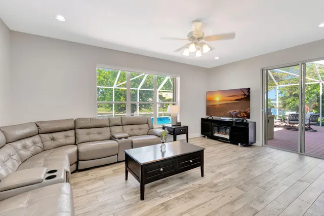 a view of a backyard with wooden floor and iron fence