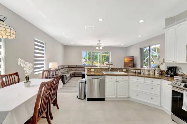 an aerial view of residential houses with outdoor space and swimming pool