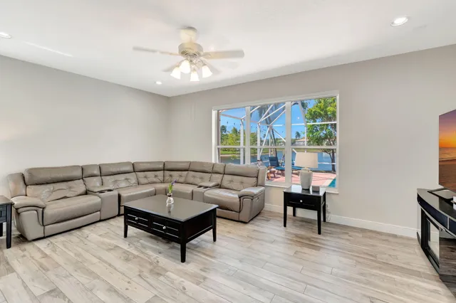 an aerial view of a house with a swimming pool and garden
