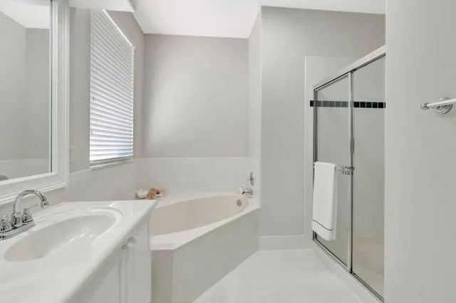 a front view of a house with a yard and tree s