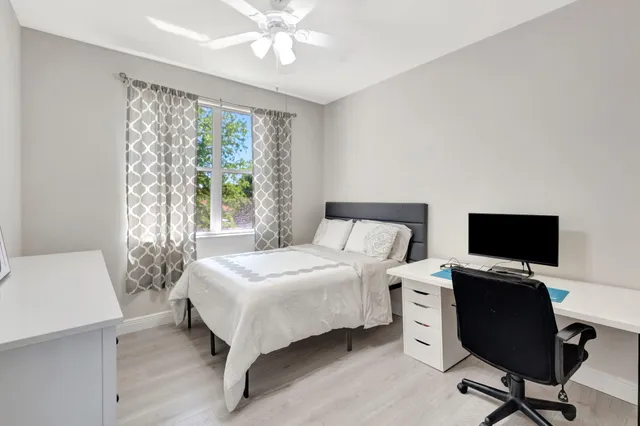 a view of a swimming pool with red chairs