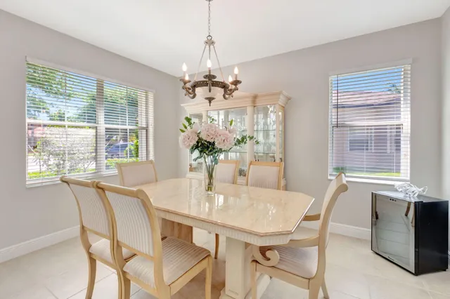 a living room with furniture a large window and a flat screen tv