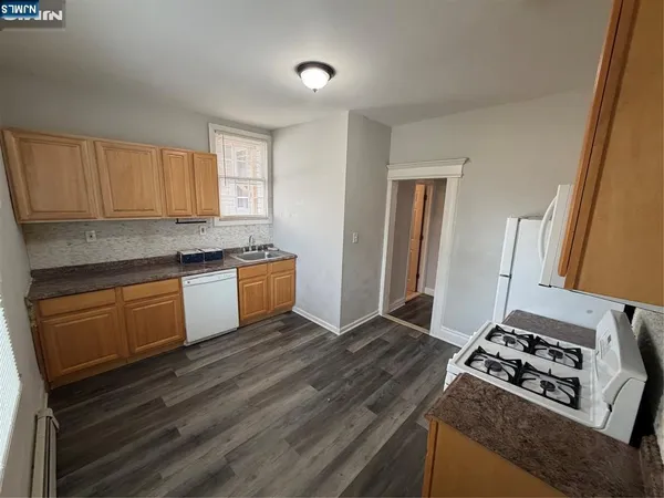 a kitchen with granite countertop a stove and a sink