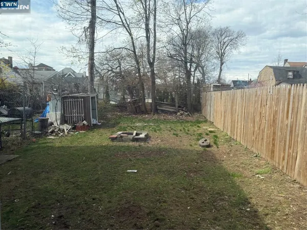 a view of a backyard with large trees