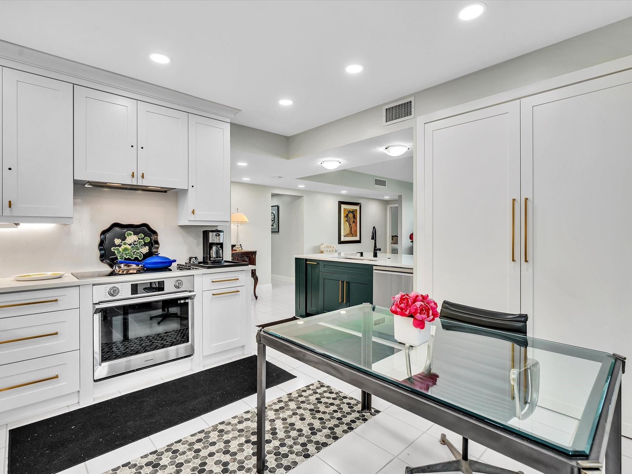 7642 Elm Ridge Drive, Unit 14L Boca Raton, FL 33433 - Photo 11 of 69 a kitchen with granite countertop white cabinets and white appliances