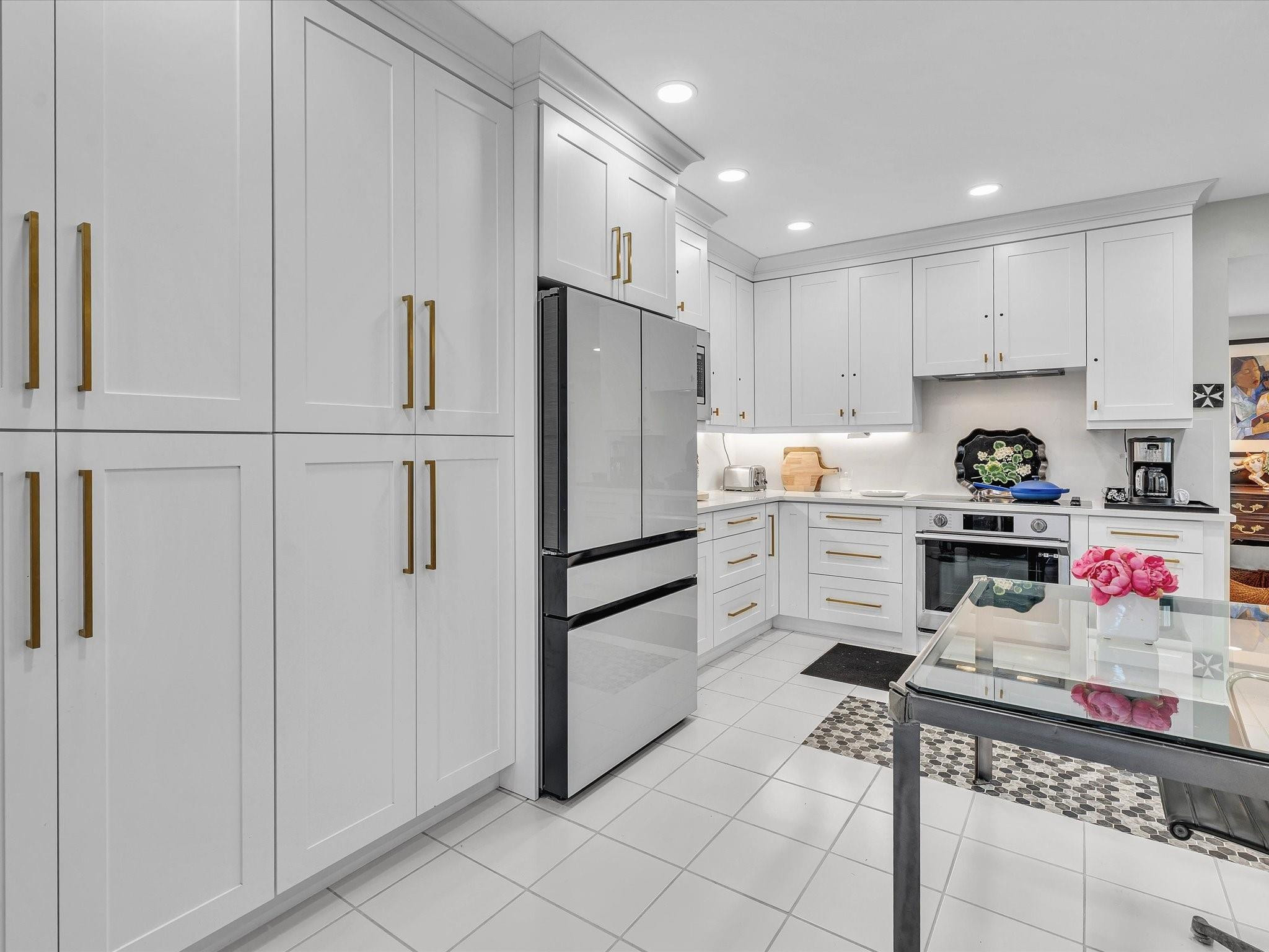 7642 Elm Ridge Drive, Unit 14L Boca Raton, FL 33433 - Photo 15 of 69 a kitchen with stainless steel appliances a refrigerator sink and cabinets