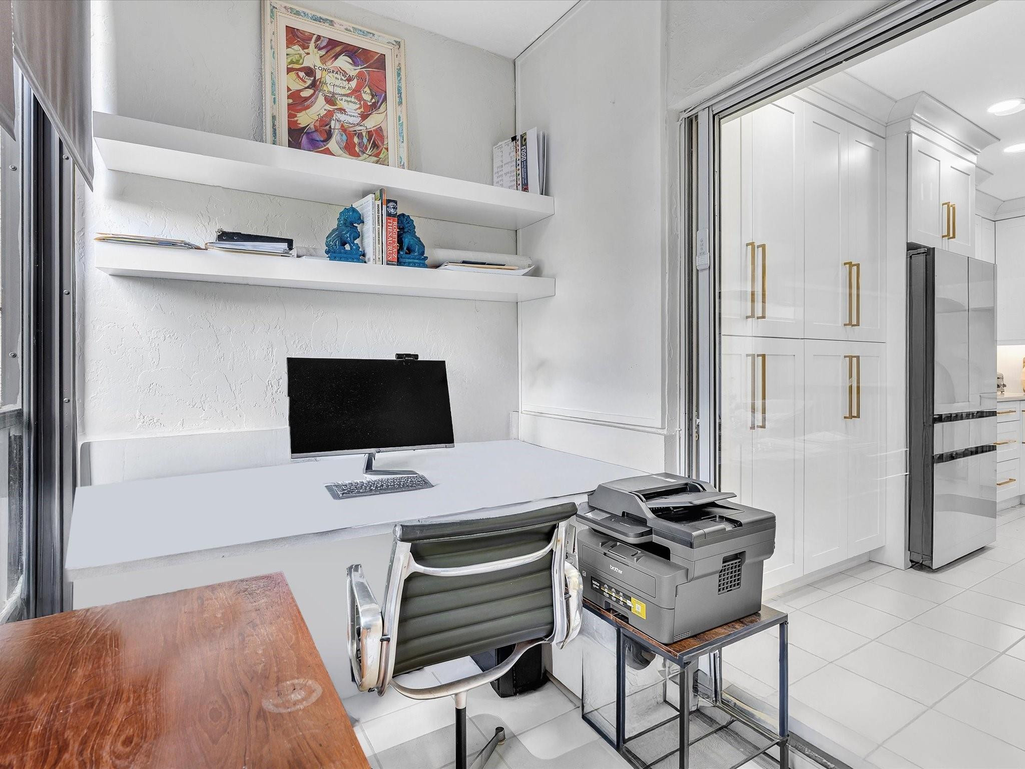 7642 Elm Ridge Drive, Unit 14L Boca Raton, FL 33433 - Photo 19 of 69 a desk with a workspace and a couch